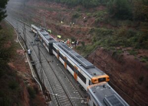 Rescue workers survey the scene after a commuter train derailed between Terrassa and Manresa, outside Barcelona